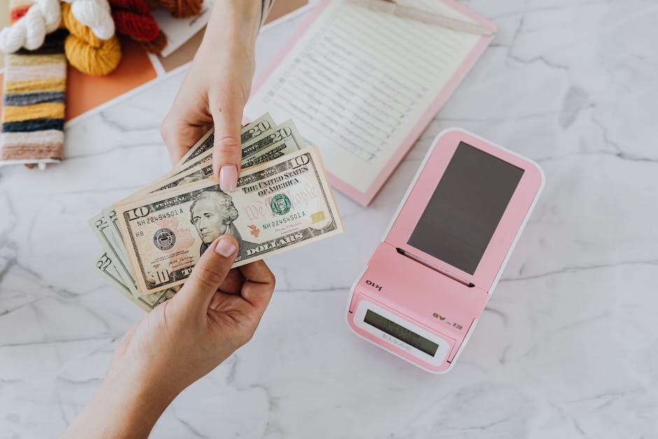 two hands holding dollars for their joint financials