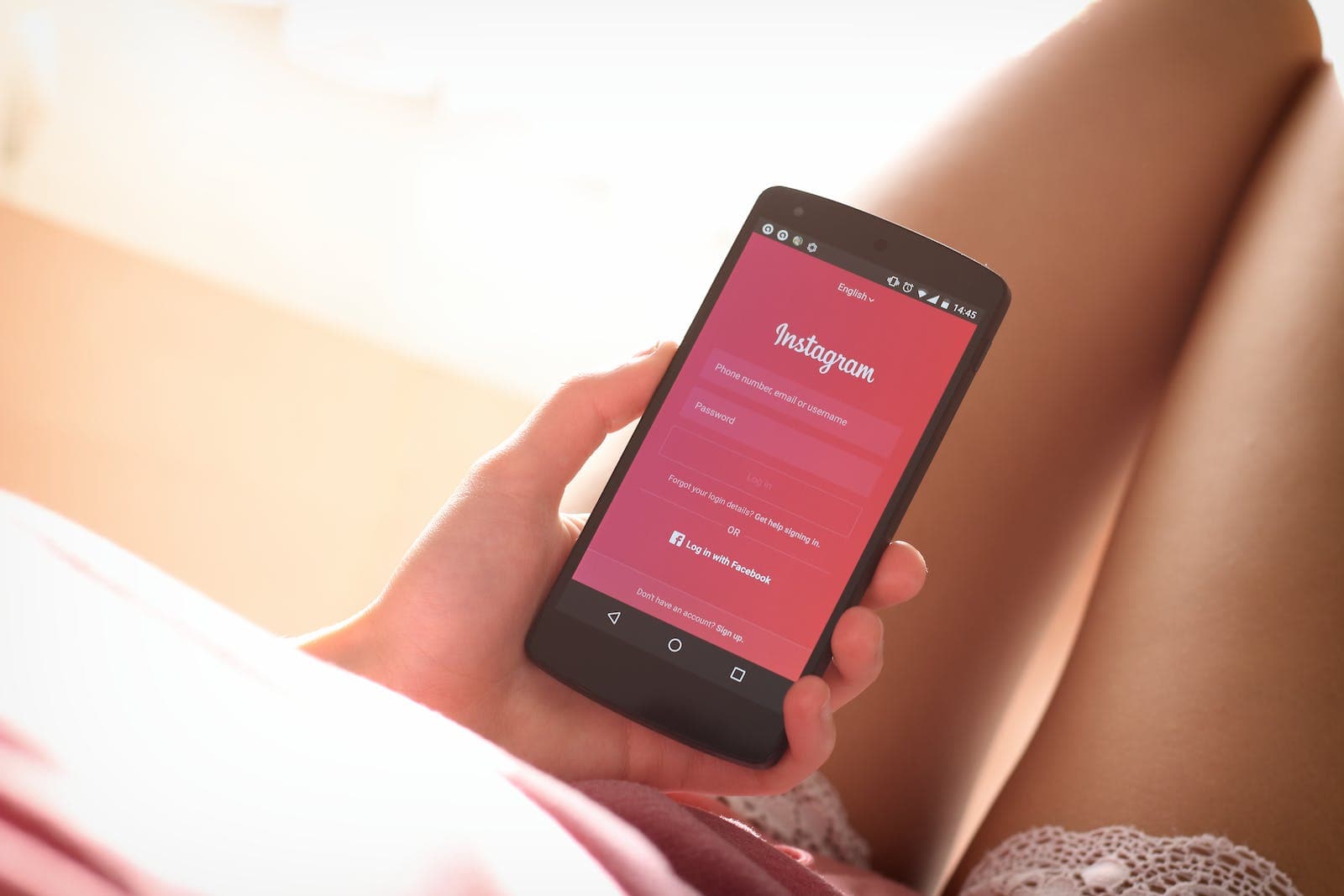 Woman Holding Black Smartphone with Instagram app in front