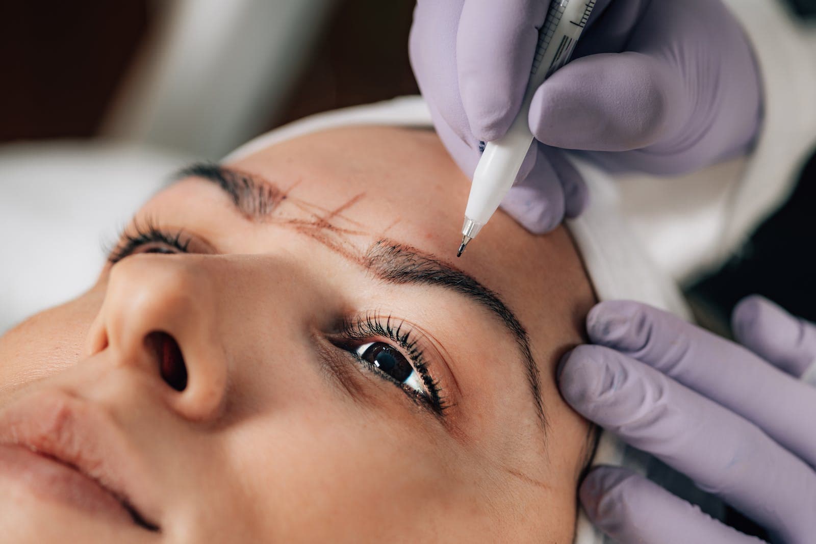 Close-up of Beautician Doing Permanent Brow Tattoo (Micro Blading)