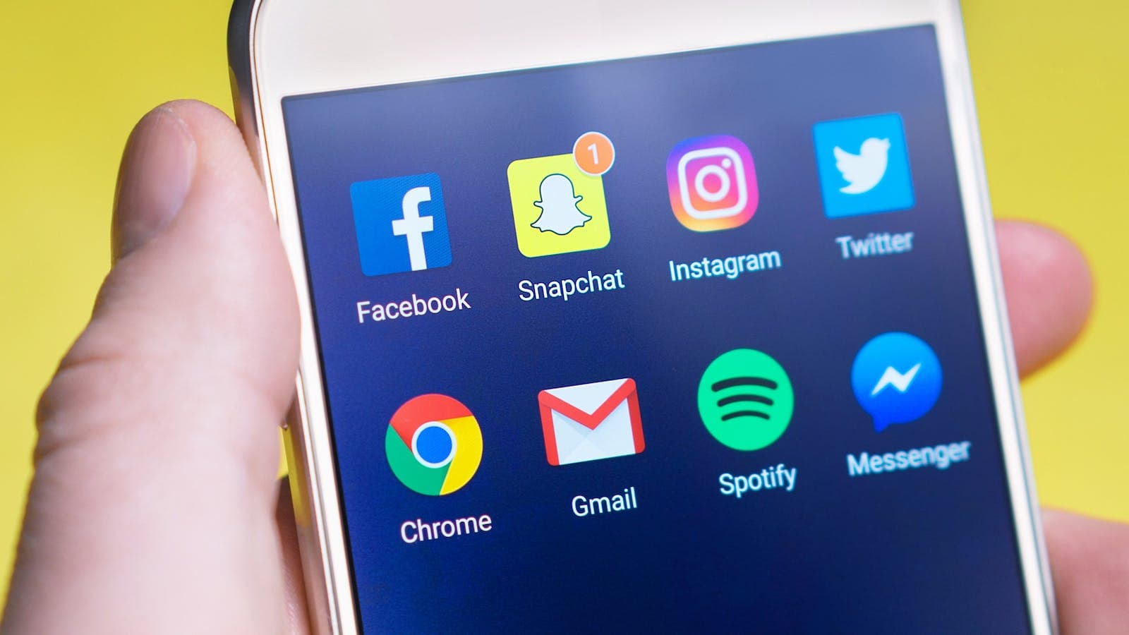 Person Holding Turned-on Android Smartphone displaying social media apps